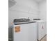 Well-equipped laundry room featuring a new washer and dryer, and a wire shelf for storing supplies at 3705 Rosebush Dr, Zebulon, NC 27597