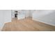 Open-concept living area flows into the kitchen with stunning hardwood floors at 3705 Rosebush Dr, Zebulon, NC 27597