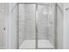 Modern walk-in shower with a glass door and tiled walls at 3705 Rosebush Dr, Zebulon, NC 27597