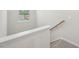 Staircase with white banister and carpeted steps at 3705 Rosebush Dr, Zebulon, NC 27597
