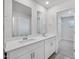 Bathroom with dual sink vanity, mirror, and entrance to walk in closet at 3707 Rosebush Dr, Zebulon, NC 27597