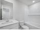 Bright bathroom featuring vanity with white cabinets, mirror, and tub with tiled shower at 3707 Rosebush Dr, Zebulon, NC 27597