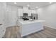 Well-lit kitchen featuring white cabinets, stainless steel appliances, and a functional island with breakfast bar at 3707 Rosebush Dr, Zebulon, NC 27597