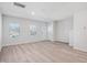 Inviting living room boasts new hardwood floors, windows with blinds, and a pristine white door and trim at 3707 Rosebush Dr, Zebulon, NC 27597