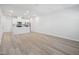 Open-concept living space features sleek hardwood floors, a modern kitchen, and plentiful natural light at 3707 Rosebush Dr, Zebulon, NC 27597
