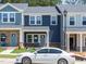 Charming townhouse featuring horizontal navy siding, gray door and brick accents at 3709 Rosebush Dr, Zebulon, NC 27597