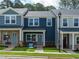 Charming townhomes with blue siding, brick accents, and well-maintained front yards at 3709 Rosebush Dr, Zebulon, NC 27597