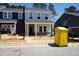 New two-story home with light gray exterior, brick accents, and visible construction activity at 3711 Rosebush Dr, Zebulon, NC 27597