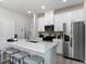 Bright kitchen featuring white cabinets, stainless steel appliances, and quartz countertops at 3711 Rosebush Dr, Zebulon, NC 27597
