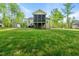 View of backyard featuring a green lawn, shed and covered porch at 3805 Watermark Dr, Franklinton, NC 27525