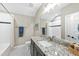 Bathroom with a white vanity with granite countertops, black-and-white tile floors, and shower at 3805 Watermark Dr, Franklinton, NC 27525
