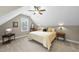 Cozy carpeted bedroom featuring a pitched ceiling, vintage wooden dresser, and comfortable bed at 3805 Watermark Dr, Franklinton, NC 27525
