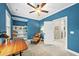 Bright bedroom with blue walls, carpet and built-in shelves, next to the door at 3805 Watermark Dr, Franklinton, NC 27525