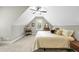 Cozy carpeted bedroom featuring a pitched ceiling and vintage wooden dresser at 3805 Watermark Dr, Franklinton, NC 27525