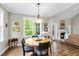 Cozy dining area with large windows offering beautiful views and a stone fireplace nearby at 3805 Watermark Dr, Franklinton, NC 27525