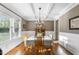 Bright dining room boasts coffered ceilings, hardwood floors, and large window at 3805 Watermark Dr, Franklinton, NC 27525