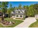Beautiful home with manicured lawn, stone accents, professional landscaping, and a long concrete driveway at 3805 Watermark Dr, Franklinton, NC 27525