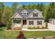 Charming home featuring a manicured lawn, stone accents, and inviting front porch at 3805 Watermark Dr, Franklinton, NC 27525