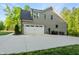 Spacious two-car garage with a long concrete driveway and mature landscaping at 3805 Watermark Dr, Franklinton, NC 27525