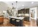 Well-lit kitchen features stainless appliances, granite counters, center island and access to living spaces at 3805 Watermark Dr, Franklinton, NC 27525