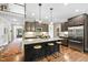 Open kitchen boasts granite counters, stainless appliances, pendant lighting, and hardwood floors throughout at 3805 Watermark Dr, Franklinton, NC 27525