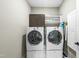 Laundry room with side-by-side washer and dryer units and built-in storage at 3805 Watermark Dr, Franklinton, NC 27525