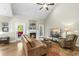 Bright living room showcases a stone fireplace, hardwood floors and access to a deck at 3805 Watermark Dr, Franklinton, NC 27525