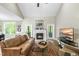 Comfortable living room offers hardwood floors, fireplace, and access to outdoor spaces at 3805 Watermark Dr, Franklinton, NC 27525