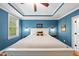 A large main bedroom with blue walls, ceiling fan, and white trim at 3805 Watermark Dr, Franklinton, NC 27525