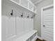 Mudroom with built-in bench seating and coat hooks for organization at 3805 Watermark Dr, Franklinton, NC 27525