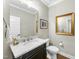 Half bath features a vanity with granite countertop and decorative mirror at 3805 Watermark Dr, Franklinton, NC 27525