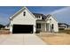 Charming new two-story home with a two-car garage, board and batten siding, and a welcoming front porch at 3820 Fairway View Dr # 16, Fuquay Varina, NC 27526