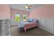 Bright bedroom with paneled accent wall, two large windows, and plush carpet at 3832 Crimson Clover Ave, Wake Forest, NC 27587