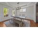 Cozy dining area with a large table, bench seating, and bright windows offering lovely outdoor views at 3832 Crimson Clover Ave, Wake Forest, NC 27587