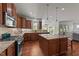 Beautiful kitchen featuring custom cabinets, stainless appliances, granite countertops and island with barstool seating at 3832 Crimson Clover Ave, Wake Forest, NC 27587