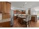 Spacious kitchen features wood cabinets, granite counters, island with seating, and stainless steel appliances at 3832 Crimson Clover Ave, Wake Forest, NC 27587