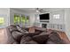 Comfortable living room with large windows, fireplace, and a plush sectional sofa for cozy Gathering gatherings at 3832 Crimson Clover Ave, Wake Forest, NC 27587