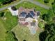 Aerial view of home with solar panels on the roof, and a patio with outdoor kitchen and fire pit in the backyard at 4001 Belmont Forest Way, Raleigh, NC 27606