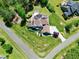 Gorgeous aerial shot of a home with a lush yard, long driveway, and patio and outdoor kitchen at 4001 Belmont Forest Way, Raleigh, NC 27606