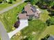 Aerial view showcasing a solar-paneled roof, outdoor kitchen, and backyard patio with lush surroundings at 4001 Belmont Forest Way, Raleigh, NC 27606