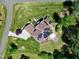 An aerial view features this solar paneled home, with a patio, backyard, lush landscaping, and long driveway at 4001 Belmont Forest Way, Raleigh, NC 27606