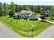 Stunning aerial view of a large, well-maintained home with lush green lawn, manicured landscaping and a basketball hoop at 4001 Belmont Forest Way, Raleigh, NC 27606