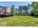 Expansive backyard featuring a deck and a cozy firepit area, perfect for outdoor entertaining at 4001 Belmont Forest Way, Raleigh, NC 27606