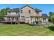 Spacious backyard with a stone firepit, wood pergola, and deck at 4001 Belmont Forest Way, Raleigh, NC 27606