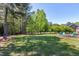 Scenic view of backyard with firepit and tree line at 4001 Belmont Forest Way, Raleigh, NC 27606