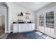 Bright bar area with white cabinets, shelves and glass doors leading to a wooden deck at 4001 Belmont Forest Way, Raleigh, NC 27606