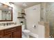 Neutral bathroom featuring a granite vanity, toilet, framed mirror and glass shower at 4001 Belmont Forest Way, Raleigh, NC 27606