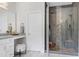 Bathroom with a modern glass enclosed shower, vanity with marble countertops, and white cabinets at 4001 Belmont Forest Way, Raleigh, NC 27606