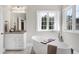 Bright bathroom with a soaking tub, marble countertop and framed mirror at 4001 Belmont Forest Way, Raleigh, NC 27606