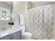 Bathroom with gray vanity, marble countertop, and a shower-tub combination at 4001 Belmont Forest Way, Raleigh, NC 27606